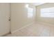 Bright bedroom features tile flooring, baseboards, and bright natural light at 4906 Cortez Dr, Orlando, FL 32808