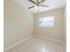 This bedroom includes tile flooring, baseboards, and a ceiling fan at 4906 Cortez Dr, Orlando, FL 32808