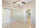 Bedroom featuring tile flooring, ceiling fan, and view to another room at 4906 Cortez Dr, Orlando, FL 32808