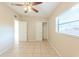 Bedroom featuring tile flooring, closet, ceiling fan, and window at 4906 Cortez Dr, Orlando, FL 32808
