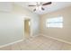 Bedroom featuring tile flooring, ceiling fan, and window at 4906 Cortez Dr, Orlando, FL 32808