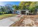 Quaint home with a covered parking area, set on a lot with mature trees and a concrete driveway at 4906 Cortez Dr, Orlando, FL 32808
