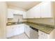 This kitchen is equipped with granite countertops and white cabinets at 4906 Cortez Dr, Orlando, FL 32808