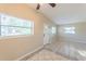 Bright, airy living room with tiled floors, neutral walls, a ceiling fan, and natural lighting at 4906 Cortez Dr, Orlando, FL 32808