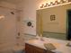 Bathroom with neutral tile flooring, a shower-tub combination, and double sink vanity at 506 Freeman St, Longwood, FL 32750