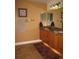 Bathroom boasts a vanity with dark countertops, wooden cabinets, and tile flooring at 506 Freeman St, Longwood, FL 32750