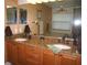 A double-sink bathroom vanity with granite countertops and wood cabinets at 506 Freeman St, Longwood, FL 32750