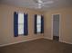 Cozy bedroom features two windows, plush carpet, and neutral walls at 506 Freeman St, Longwood, FL 32750