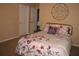 Comfortable bedroom with floral bedding, decorative wall art and closet space for storage at 506 Freeman St, Longwood, FL 32750