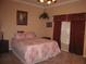 Comfortable bedroom with patterned bedding, dark curtains, and a ceiling fan at 506 Freeman St, Longwood, FL 32750