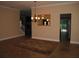 Open dining area with chandelier, adjacent to staircase and view to the exterior at 506 Freeman St, Longwood, FL 32750