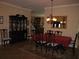 Elegant dining room with a dark china cabinet, traditional furniture and chandelier at 506 Freeman St, Longwood, FL 32750