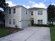 Charming two-story home featuring a spacious driveway, attached garage, and well-manicured landscaping at 506 Freeman St, Longwood, FL 32750