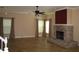 Spacious living room featuring a classic brick fireplace and large windows for ample natural light at 506 Freeman St, Longwood, FL 32750