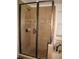 Shower with glass doors and tile walls at 506 Freeman St, Longwood, FL 32750