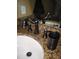 Close-up of a bathroom sink featuring granite countertops, oil rubbed bronze fixtures, and a curved faucet at 506 Freeman St, Longwood, FL 32750