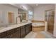 Bathroom featuring double sinks, soaking tub, tiled shower, and linen closet for storage at 5201 Villa Rosa Ave, St Cloud, FL 34771