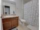 Full bathroom featuring a shower/tub combo, neutral tile floors, and a granite countertop at 5201 Villa Rosa Ave, St Cloud, FL 34771