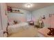 Pastel bedroom with charming decor, including a vanity, pink chair, and plush bedding at 5201 Villa Rosa Ave, St Cloud, FL 34771