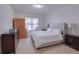 Neutral bedroom featuring a large bed, soft carpet, and plenty of natural light from a window at 5201 Villa Rosa Ave, St Cloud, FL 34771