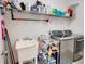 Functional laundry room with modern washer and dryer, ample shelving, and a utility sink at 5201 Villa Rosa Ave, St Cloud, FL 34771