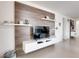 Modern living room with sleek TV console, decorative wall, and floating shelves at 5201 Villa Rosa Ave, St Cloud, FL 34771