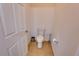 Toilet room with tiled floors, white toilet, and door, perfect for privacy at 5201 Villa Rosa Ave, St Cloud, FL 34771