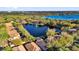 Aerial view of the neighborhood featuring a pond with a fountain, lush trees, and well-maintained homes at 6145 Froggatt St, Orlando, FL 32835