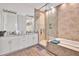 Stylish bathroom with a glass walk-in shower, soaking tub, and modern fixtures at 6145 Froggatt St, Orlando, FL 32835