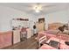 Bright bedroom featuring a vanity area and a comfortable bed with pink bedding at 6145 Froggatt St, Orlando, FL 32835