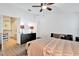 Bedroom featuring hardwood floors, a ceiling fan, and an ensuite bathroom with modern fixtures at 6145 Froggatt St, Orlando, FL 32835