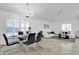 Open concept dining room with a chandelier, neutral paint, ceramic tile floors and black chairs at 6145 Froggatt St, Orlando, FL 32835