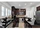 Spacious kitchen featuring dark wood cabinets, stainless steel appliances, and plenty of counter space at 6145 Froggatt St, Orlando, FL 32835