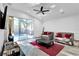 Bright living room featuring tile floors, comfortable seating, and a sliding glass door to the pool area at 6145 Froggatt St, Orlando, FL 32835