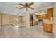 Bright living room opens into kitchen, featuring a combination of tile flooring and neutral walls at 7529 Winter Shade Dr, Orlando, FL 32822