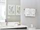 Bright bathroom with a modern vanity, large mirror, and decorative artwork at 7740 Sandy Ridge Dr # 136, Reunion, FL 34747