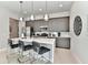 Modern kitchen with stainless steel appliances, an island with seating, and stylish pendant lighting at 7740 Sandy Ridge Dr # 136, Reunion, FL 34747