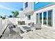 Outdoor patio area features sleek modern furniture and sliding door access at 7740 Sandy Ridge Dr # 136, Reunion, FL 34747