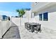 Outdoor patio with modern dining and white privacy fence at 7740 Sandy Ridge Dr # 136, Reunion, FL 34747