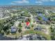 Aerial view showcases the home's location in a lush, green neighborhood near a lake, ideal for families at 789 Kangaroo Ct, Deltona, FL 32738