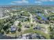 Aerial view showcases the home's location in a lush, green neighborhood near a lake, ideal for families at 789 Kangaroo Ct, Deltona, FL 32738