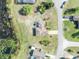 Aerial view of a cozy single-Gathering home with a pool, surrounded by lush greenery and a serene pond at 789 Kangaroo Ct, Deltona, FL 32738