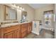 Bathroom features double sinks, granite countertops, and a soaking tub with a view of the backyard at 789 Kangaroo Ct, Deltona, FL 32738