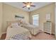 Inviting bedroom featuring twin beds, neutral walls, and a decorative dresser at 789 Kangaroo Ct, Deltona, FL 32738