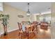 Cozy dining room with wood floors and matching wooden table set adjoining the living room at 789 Kangaroo Ct, Deltona, FL 32738