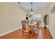 Cozy dining room with wood floors and matching wooden table set lit by a hanging pendant light at 789 Kangaroo Ct, Deltona, FL 32738