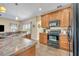 Kitchen view showcasing stainless appliances and granite counters with wood cabinets at 789 Kangaroo Ct, Deltona, FL 32738