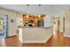 Kitchen view featuring a breakfast bar with granite counters and wood cabinets at 789 Kangaroo Ct, Deltona, FL 32738