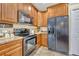 Kitchen view showcasing stainless appliances, countertops, and wood cabinets at 789 Kangaroo Ct, Deltona, FL 32738