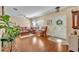 Inviting living room with hardwood floors, a comfortable leather sofa, and a plant, creating a cozy atmosphere at 789 Kangaroo Ct, Deltona, FL 32738